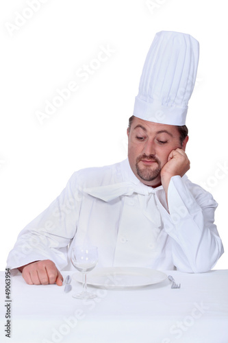 Photo: Chef looking disdainfully at an empty plate Chef looking disdainfully at an empty plate