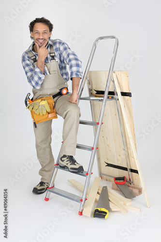 Photo: portrait of cabinetmaker posing near ladder portrait of cabinetmaker posing near ladder