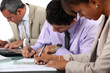 Business professionals filling in paperwork