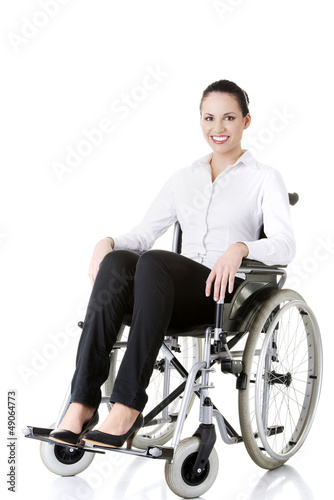 Photo: Attractive disabled businesswoman sitting in a wheel chair Attractive disabled businesswoman sitting in a wheel chair