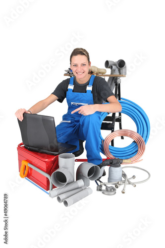 Photo: Female plumber with equipment, studio shot Female plumber with equipment, studio shot