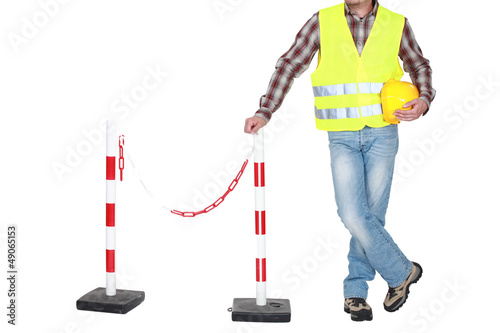Photo: Traffic guard standing beside a barrier Traffic guard standing beside a barrier