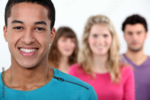 Photo: Four friends stood on white background Four friends stood on white background