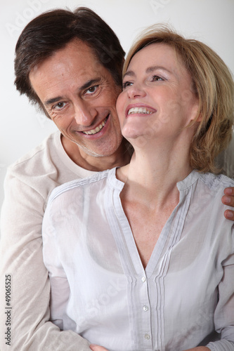 Photo: Man holding partner in arms Man holding partner in arms