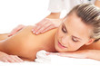 A young naked blond woman laying on a back massage
