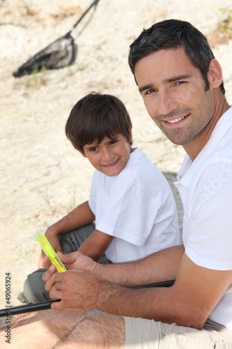 Photo: Father and son sitting on the floor Father and son sitting on the floor