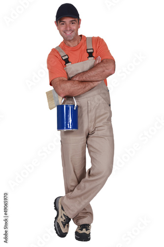 Photo: Decorator with a pot of paint Decorator with a pot of paint