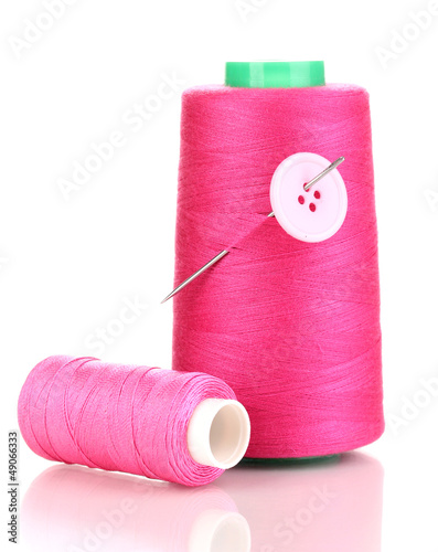Photo: Pink bobbin with needle and buttons isolated on white Pink bobbin with needle and buttons isolated on white