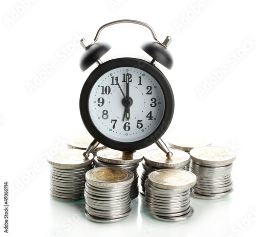 Photo: Alarm clock with coins isolated on white Alarm clock with coins isolated on white