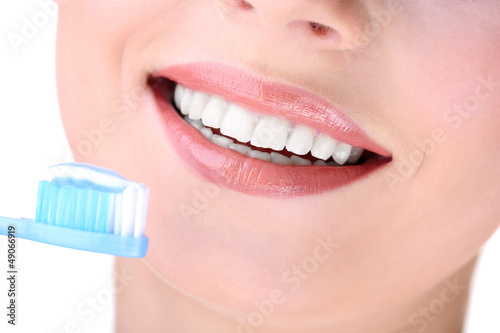 Photo: Beautiful young woman with toothbrush close-up Beautiful young woman with toothbrush close-up