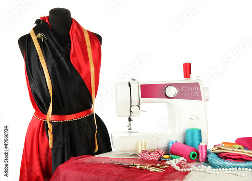 Photo: Sewing machine, dummy and other sewing equipment isolated Sewing machine, dummy and other sewing equipment isolated