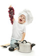 little girl in chef's hat with kitchen accessories ang grape,