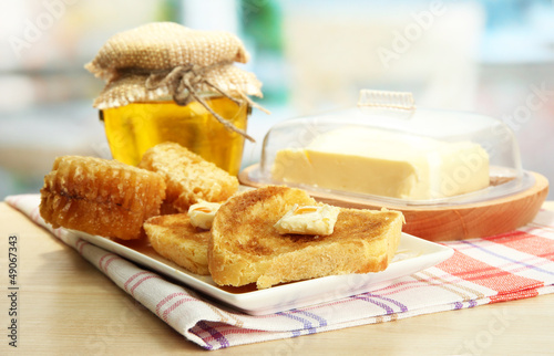 Photo: White bread toastwith honey on plate in cafe White bread toastwith honey on plate in cafe