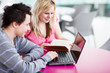 Two college students having fun studying together
