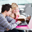 Two college students having fun studying together