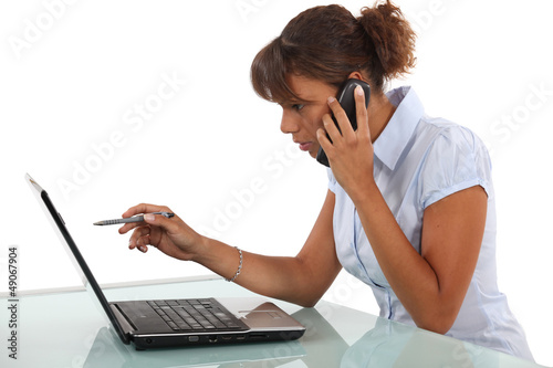 Photo: Woman calling technical help-desk Woman calling technical help-desk