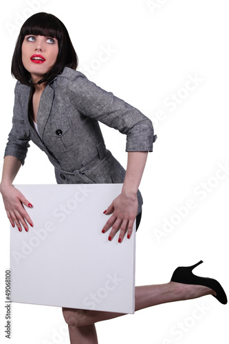 Photo: Brunette businesswoman holding messageboard Brunette businesswoman holding messageboard