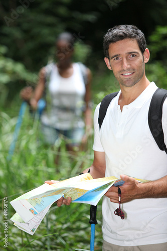 Photo: Couple hiking with a map Couple hiking with a map