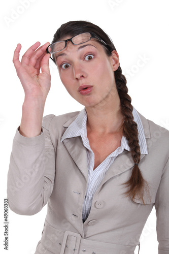 Photo: Surprised woman taking off her glasses Surprised woman taking off her glasses