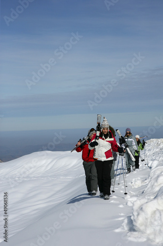 Photo: Group of skiers walking across a mountain ridge Group of skiers walking across a mountain ridge