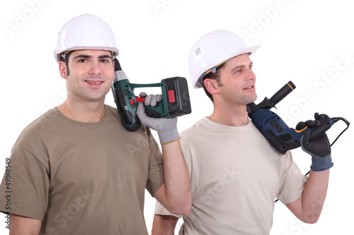 Photo: Two male builder with drills Two male builder with drills