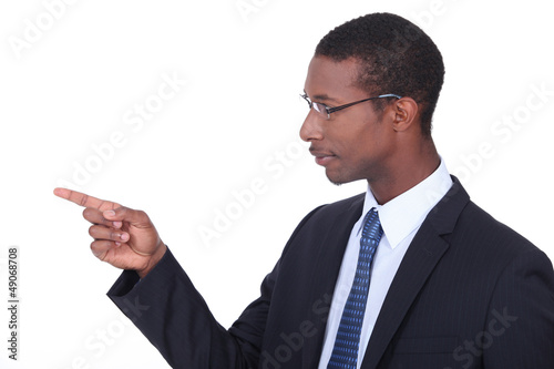 Photo: Profile shot of a man in a suit pointing his finger Profile shot of a man in a suit pointing his finger