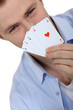Young man holding up cards