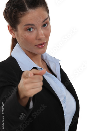 Photo: A businesswoman pointing at the camera. A businesswoman pointing at the camera.