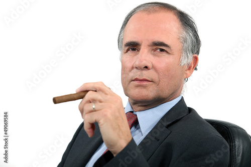 Photo: Businessman smoking cigar Businessman smoking cigar