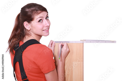Photo: female woodworker measuring a board female woodworker measuring a board