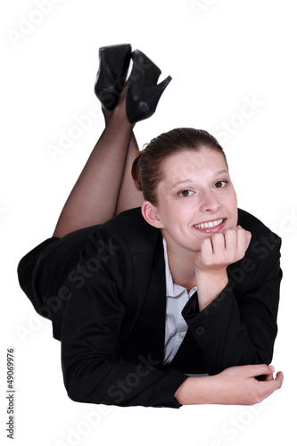 Photo: Relaxed businesswoman lying on the floor Relaxed businesswoman lying on the floor