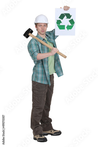 Photo: Worker holding recycle poster Worker holding recycle poster