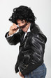 Man wearing leather jacket, sunglasses and wig
