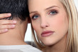 A cute blond comforting her boyfriend.