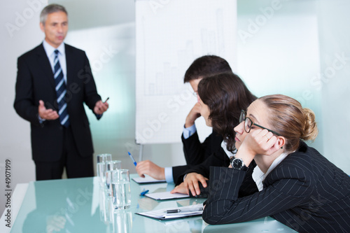 Photo: Bored businesswoman sleeping in a meeting Bored businesswoman sleeping in a meeting