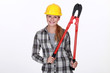 Woman holding large bolt-cutters