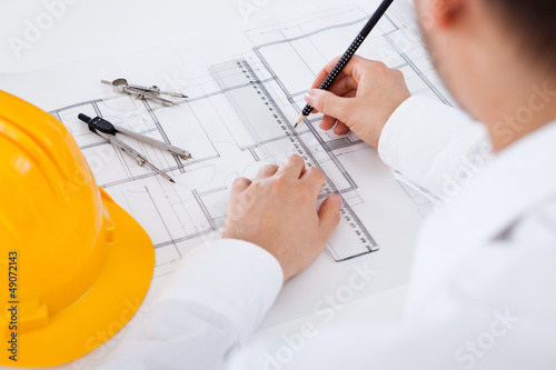 Photo: Architect working on blueprints Architect working on blueprints