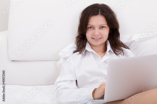 Photo: Attractive natural woman using a laptop Attractive natural woman using a laptop