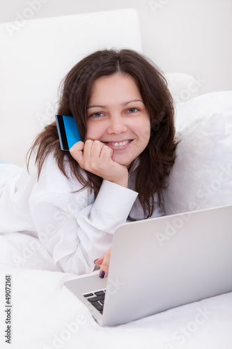 Photo: Excited woman making purchases online Excited woman making purchases online