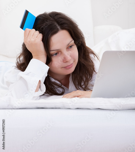 Photo: Excited woman making purchases online Excited woman making purchases online