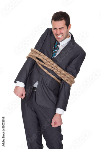 Photo: Businessman tied up in rope Businessman tied up in rope