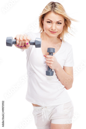 Photo: Young woman working out with dumbbells Young woman working out with dumbbells