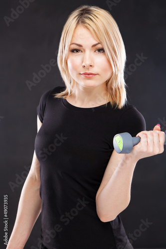 Photo: Young woman working out with dumbbells Young woman working out with dumbbells