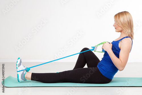 Photo: Woman exercising with a rubber band Woman exercising with a rubber band