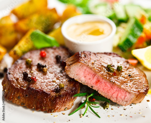 Photo: Grilled steak, baked potatoes and vegetables Grilled steak, baked potatoes and vegetables
