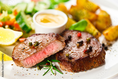 Photo: Grilled steak, baked potatoes and vegetables Grilled steak, baked potatoes and vegetables