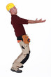 Construction worker carrying something heavy