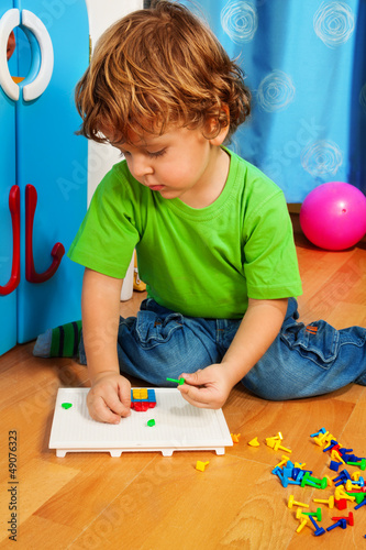 Photo: Little boy solving puzzle Little boy solving puzzle
