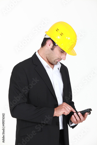 Photo: Man with helmet and cell phone Man with helmet and cell phone