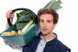 Photo: young farmer with a vegetables basket young farmer with a vegetables basket
